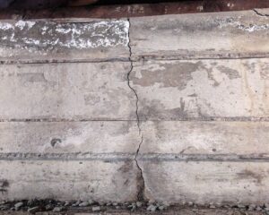 Cracked concrete foundation wall showing structural damage, a common sign of pressure on foundation wall integrity.