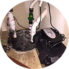 Close-up of an installed basement sump pump system with visible pump, pit basin, and discharge pipes.