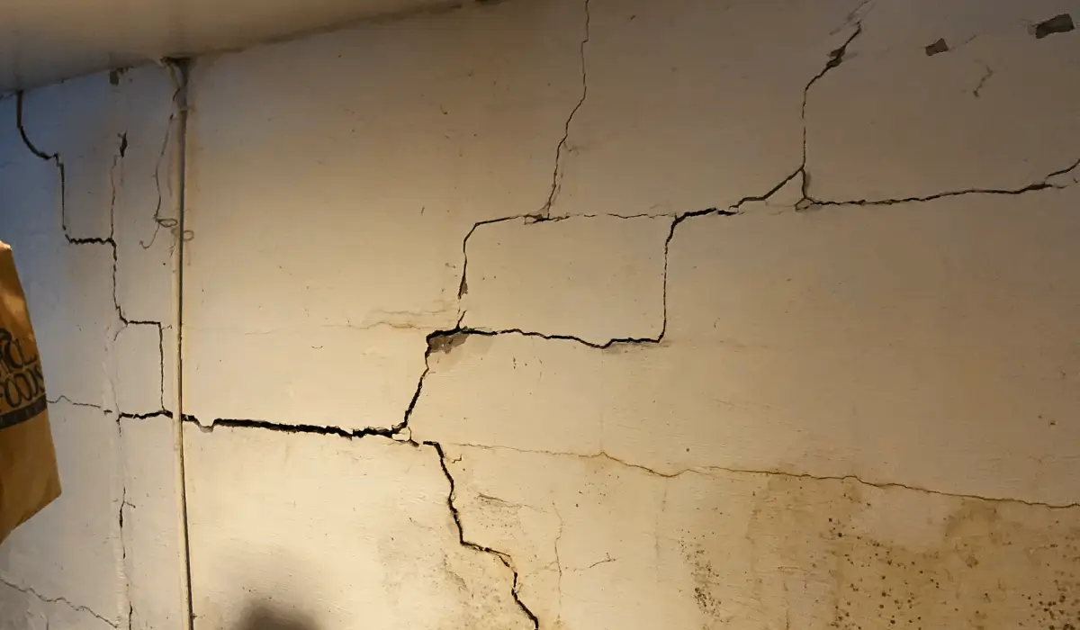Cracked basement foundation wall showing structural damage and water intrusion, a problem solved with Titan Anchors by Premium Waterproofing.