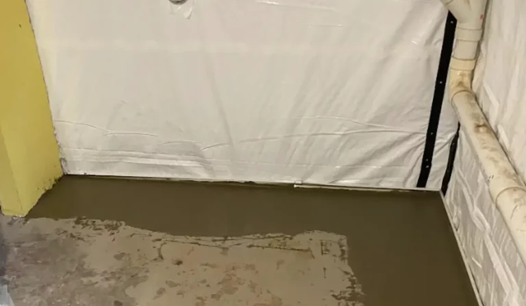 Sealed crawl space wall with installed vapor barrier showing active crawl space moisture protection process.