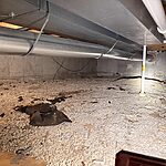 Crawl space drainage prep in Wheaton, IL with gravel base and moisture control work by Premium Waterproofing