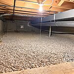 Crawl space moisture control prep in Wheaton, IL with fresh gravel base installed by Premium Waterproofing