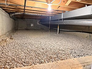 Crawl space moisture control prep in Wheaton, IL with fresh gravel base installed by Premium Waterproofing