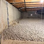 Crawl space moisture control prep with fresh gravel base and foundation sealing by Premium Waterproofing