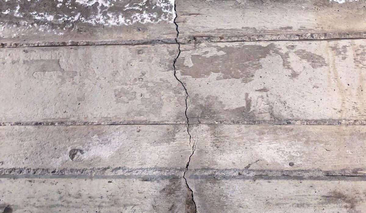 Cracked concrete foundation wall showing structural damage, a common sign of pressure on foundation wall integrity.